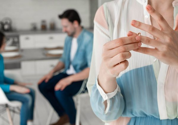 close-up-woman-taking-wedding-ring-off_23-2148548576